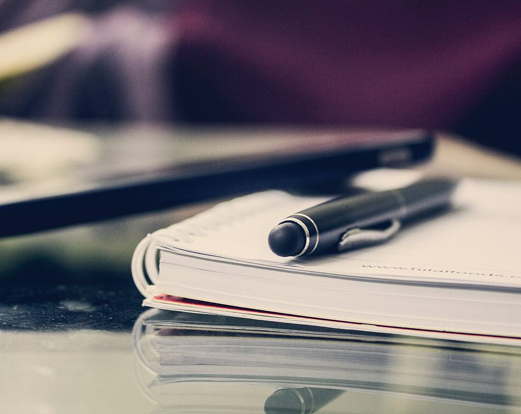 black-twist-pen-on-notebook-891059-1200x800 1